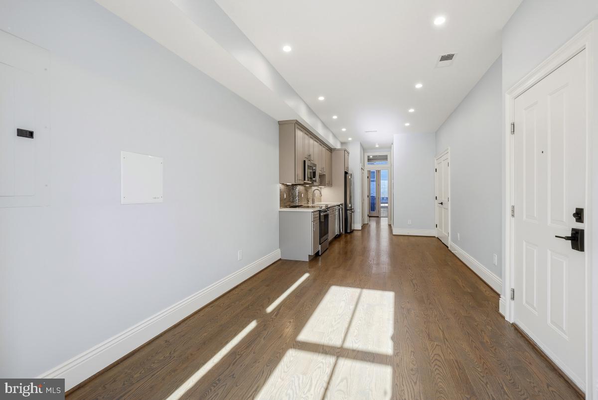 416 A Street Southeast, Unit 1 Washington, DC 20003 - Photo 10 of 30 a view of a kitchen with refrigerator and wooden floor