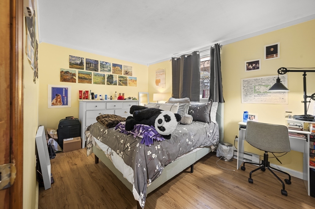 70 Jamaicaway, Unit 1 Boston, MA 02130 - Photo 12 of 19 a bed room with a bed and a chair