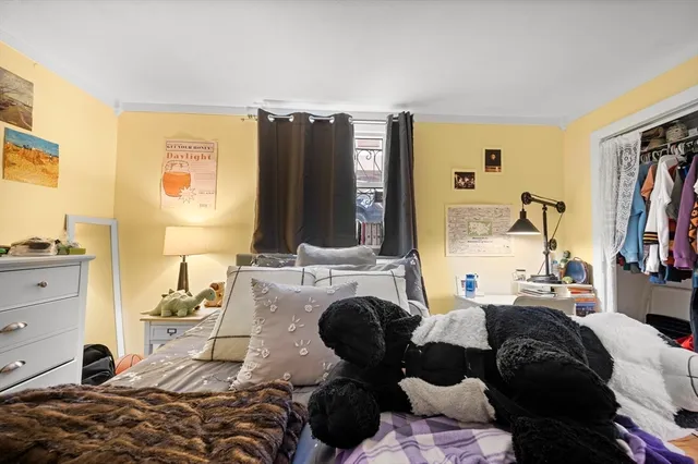 a bedroom with furniture and a flat screen tv