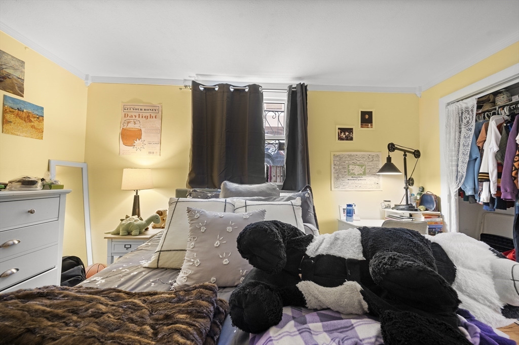 70 Jamaicaway, Unit 1 Boston, MA 02130 - Photo 14 of 19 a bedroom with furniture and a flat screen tv