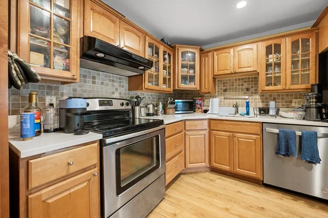 a kitchen with stainless steel appliances granite countertop a stove and a refrigerator