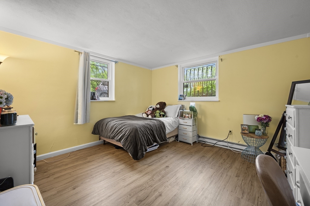 70 Jamaicaway, Unit 1 Boston, MA 02130 - Photo 9 of 19 a spacious bedroom with a bed and wooden floor