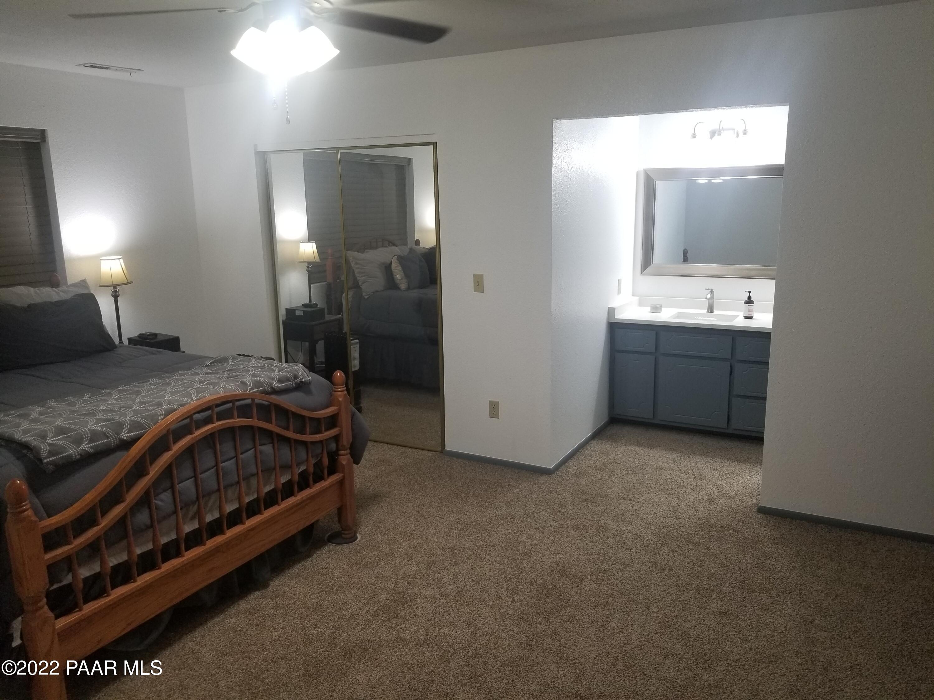 2975 North Reed Road Chino Valley, AZ 86323 - Photo 23 of 85 a spacious bedroom with a bed and a mirror