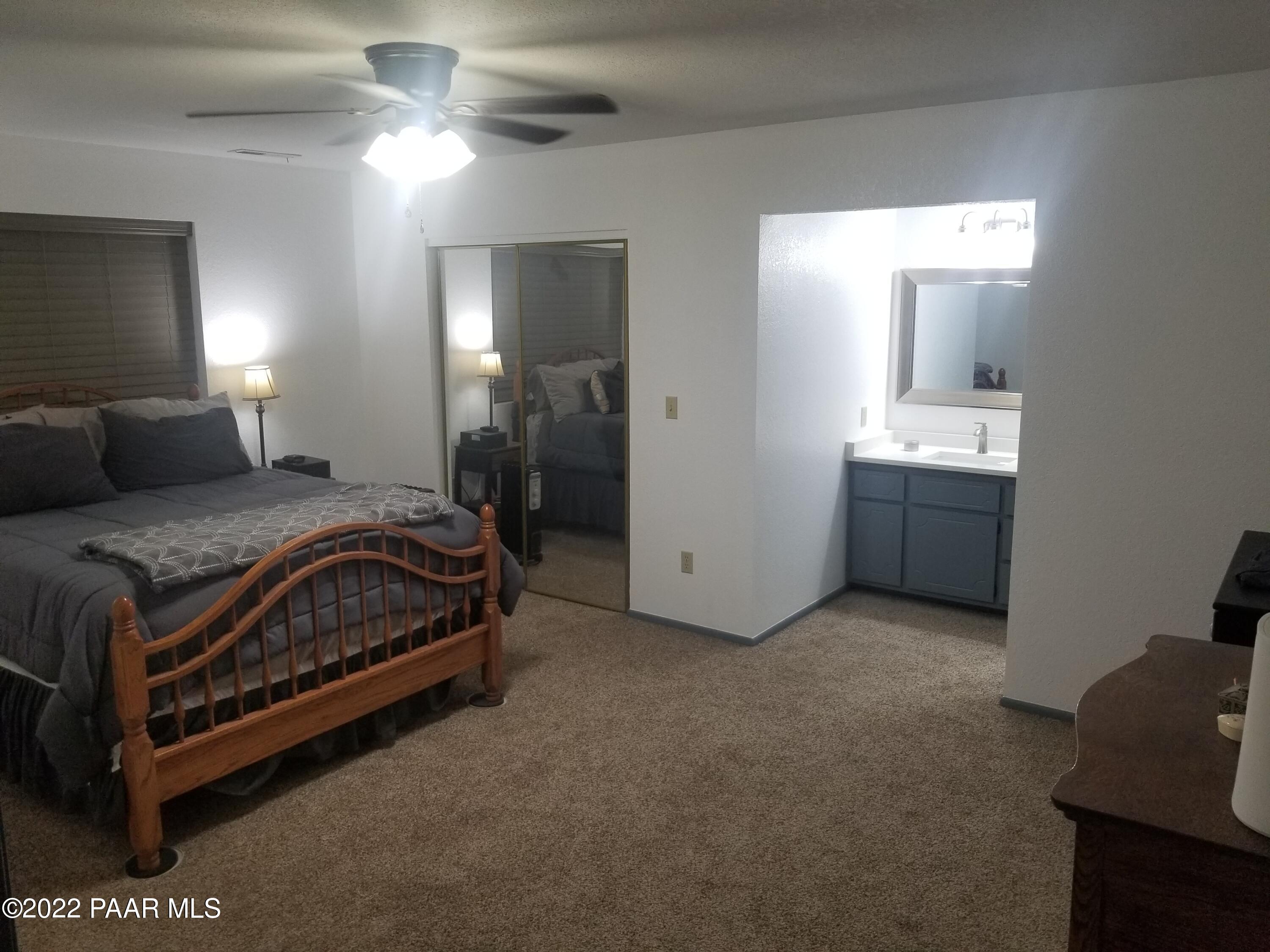 2975 North Reed Road Chino Valley, AZ 86323 - Photo 3 of 85 a spacious bedroom with a bed and a lamp on desk