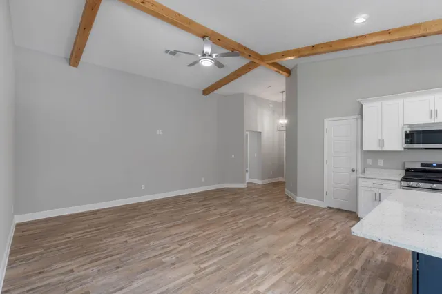 a view of a kitchen with a sink and a refrigerator