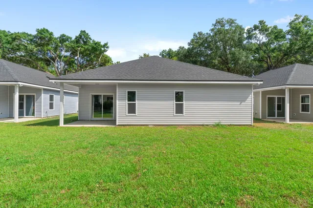 a backyard of a house with plants and garden