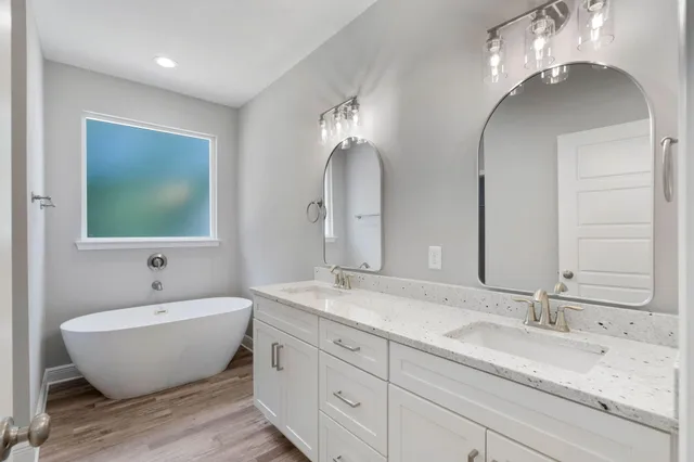 a spacious bathroom with double vanity sinks and a mirror