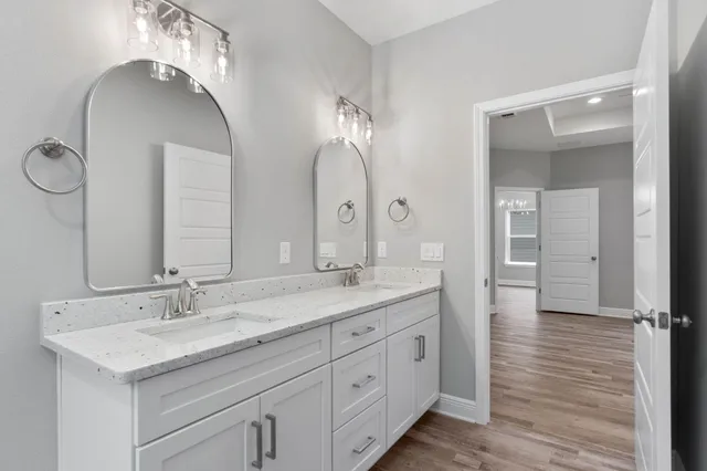 a bathroom with a double vanity sink and a mirror