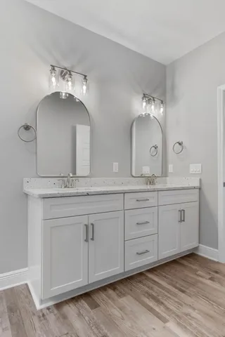 a bathroom with a double vanity sink and a mirror