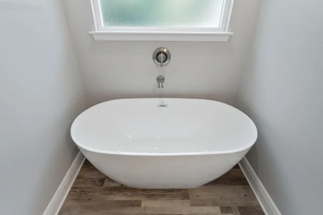a white bath tub sitting in a bathroom
