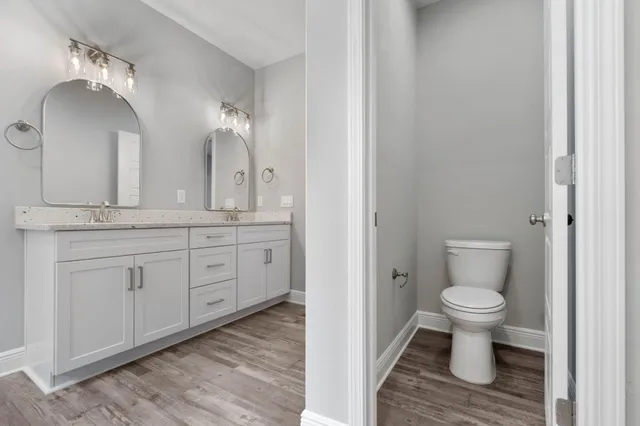a bathroom with a toilet sink and a mirror
