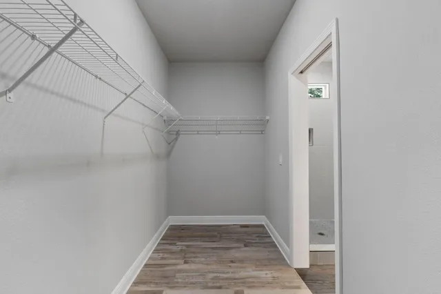 a view of a room with wooden floor