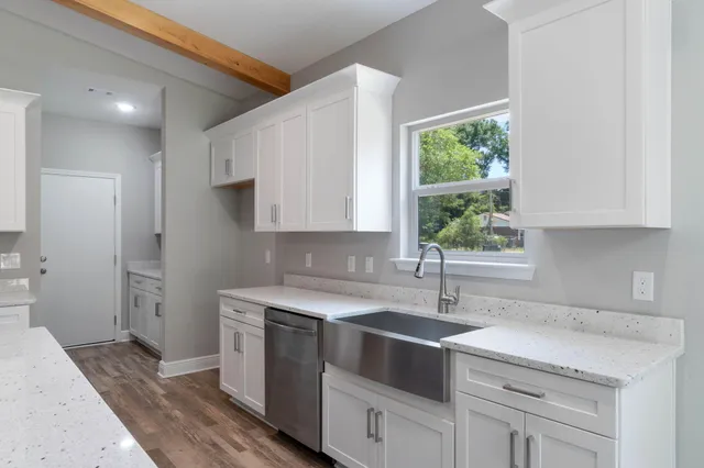 a kitchen with a sink stove and cabinets