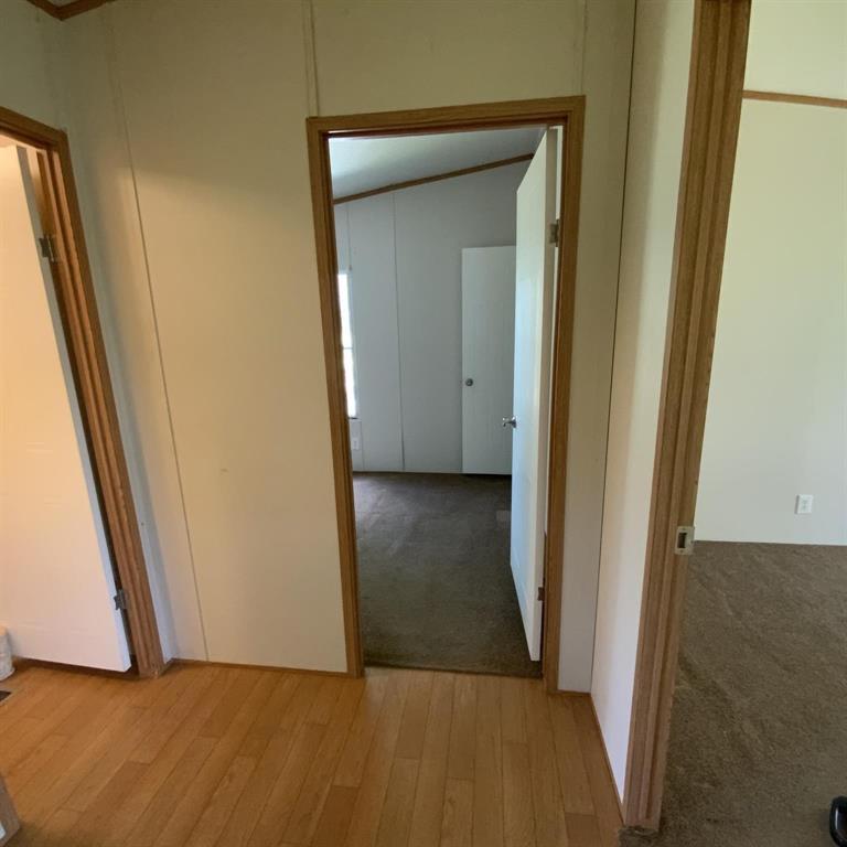 929 Neighbors Corner Road Mart, TX 76664 - Photo 18 of 28 a view of a hallway with wooden floor and closet