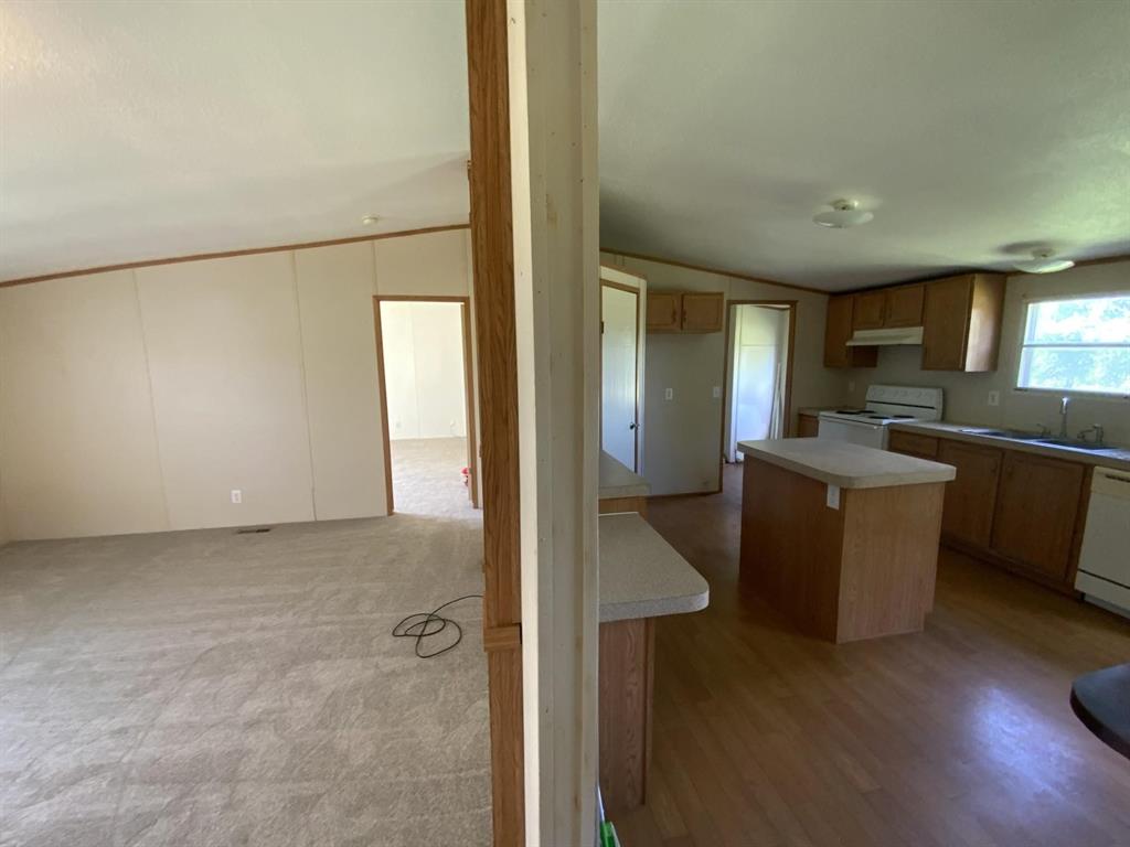 929 Neighbors Corner Road Mart, TX 76664 - Photo 7 of 28 a kitchen with a refrigerator and a sink