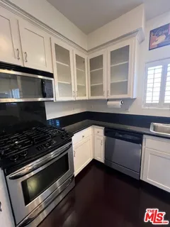 a kitchen with granite countertop a stove and a microwave