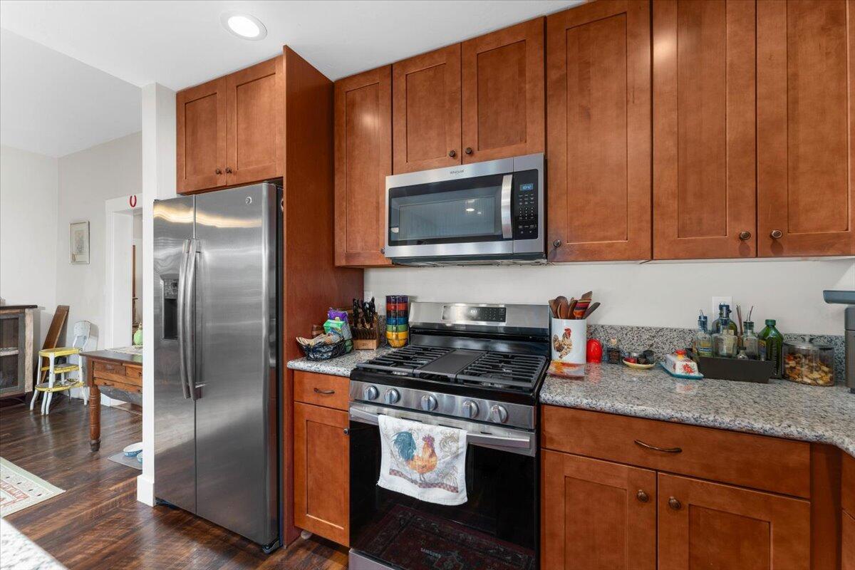 24894 Long Street Fall River Mills, CA 96028 - Photo 13 of 43 a kitchen with granite countertop stainless steel appliances a stove a refrigerator a sink a cabinets and wooden floor