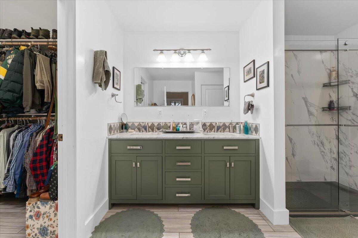 24894 Long Street Fall River Mills, CA 96028 - Photo 24 of 43 a bathroom with a granite countertop sink a mirror and a shower
