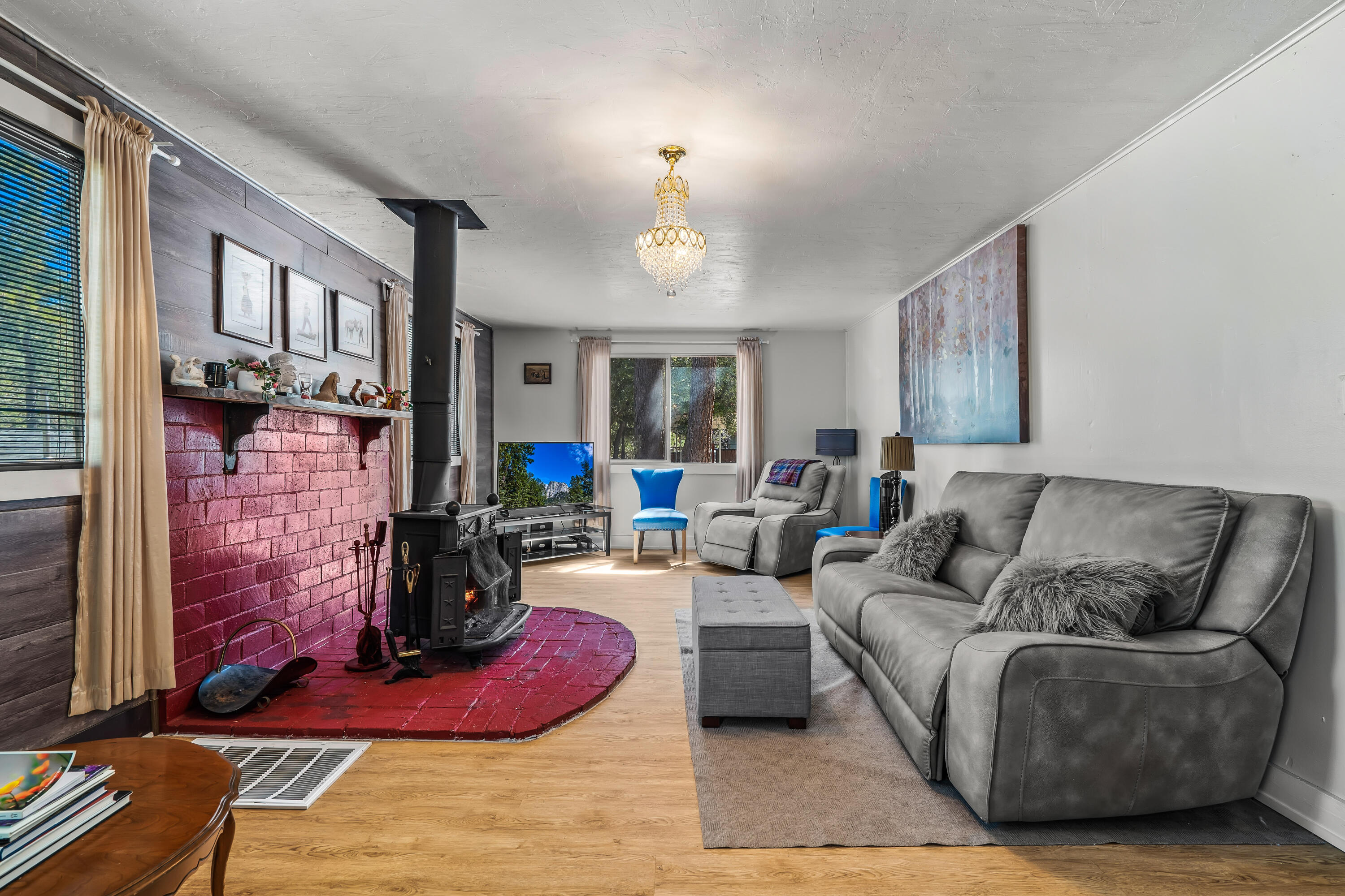 23061 Banning Idyllwild Road Idyllwild, CA 92549 - Photo 20 of 46 a living room with furniture a fireplace and a chandelier
