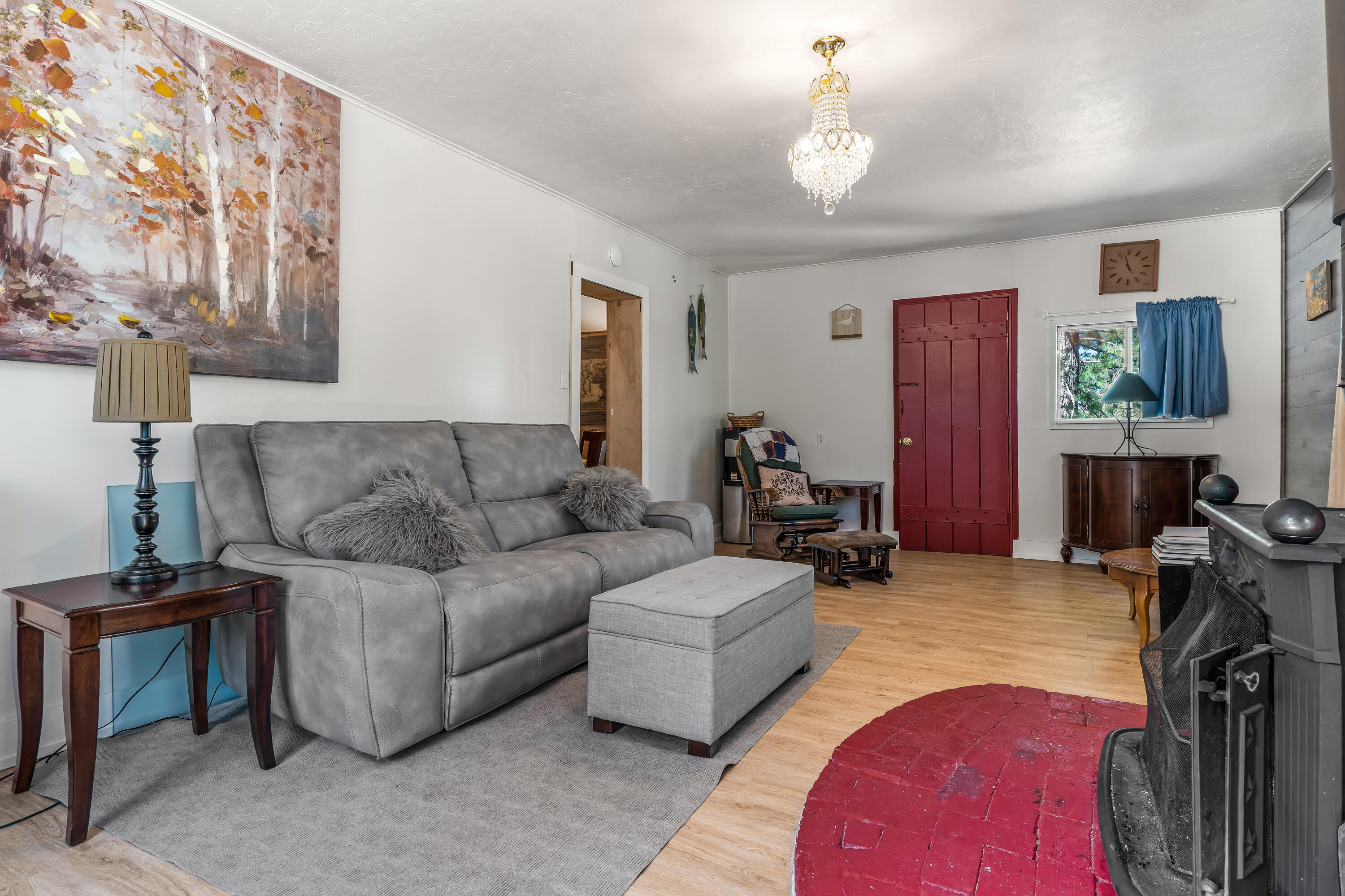 23061 Banning Idyllwild Road Idyllwild, CA 92549 - Photo 24 of 46 a living room with furniture a fireplace and a chandelier