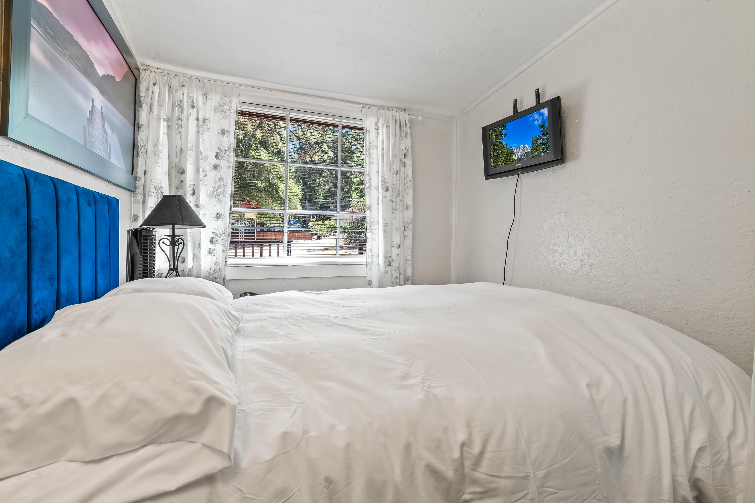 23061 Banning Idyllwild Road Idyllwild, CA 92549 - Photo 27 of 46 a bedroom with a bed and a flat screen tv