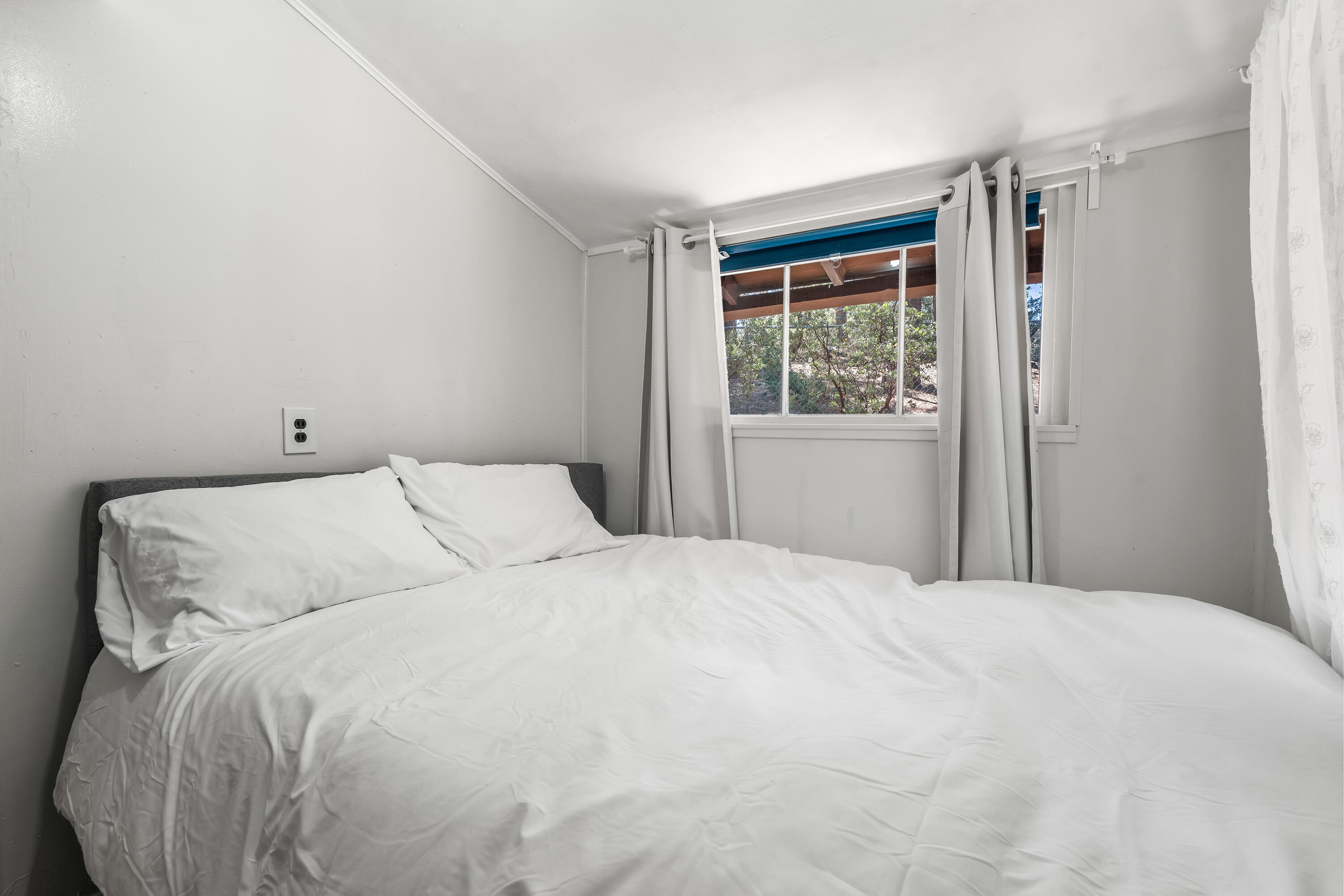 23061 Banning Idyllwild Road Idyllwild, CA 92549 - Photo 31 of 46 a large bed in a bedroom next to a window