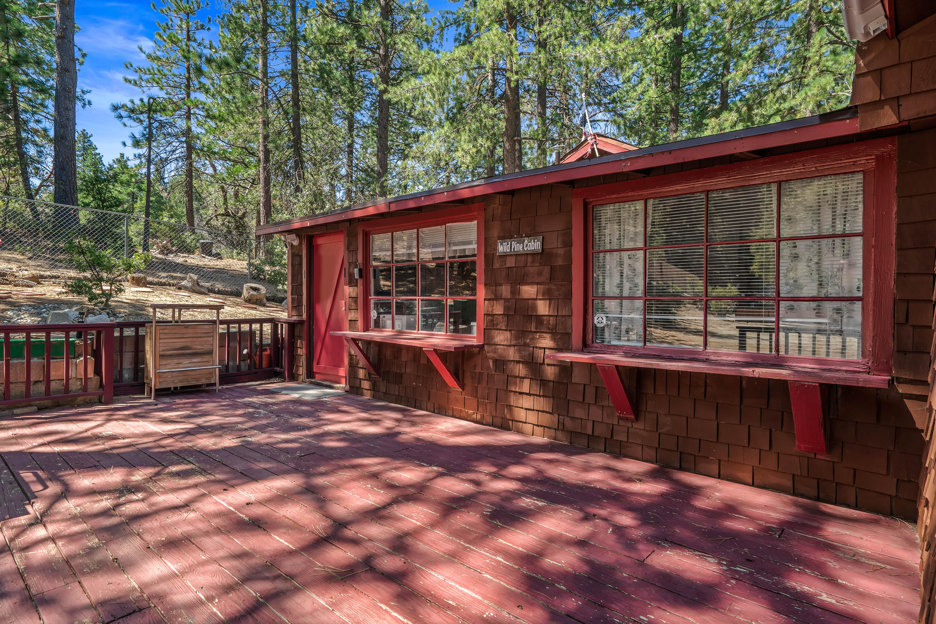 23061 Banning Idyllwild Road Idyllwild, CA 92549 - Photo 5 of 46 a view of a deck with wooden floor and roof with a garden view