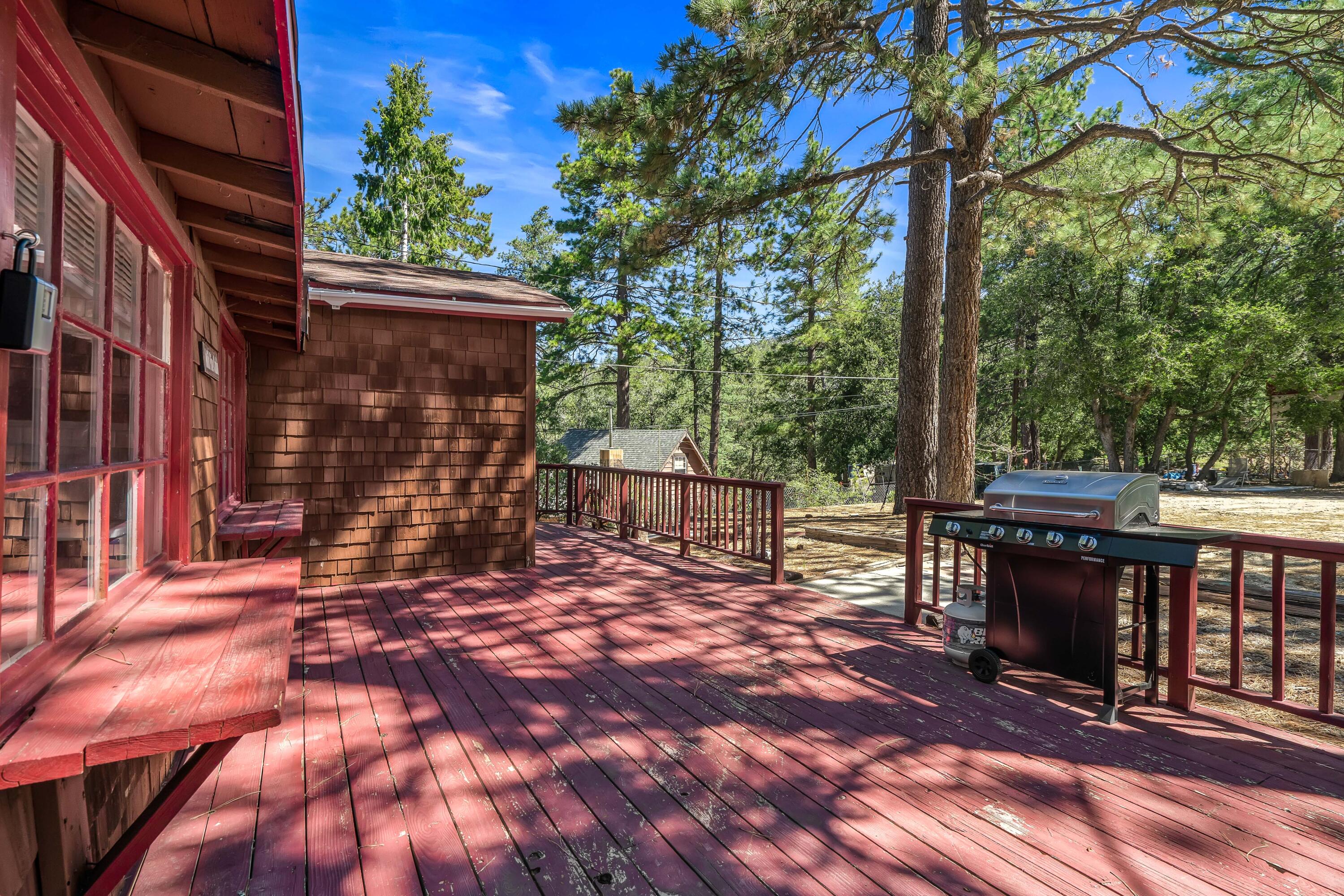 23061 Banning Idyllwild Road Idyllwild, CA 92549 - Photo 6 of 46 a view of a patio with table and chairs with wooden floor and fence