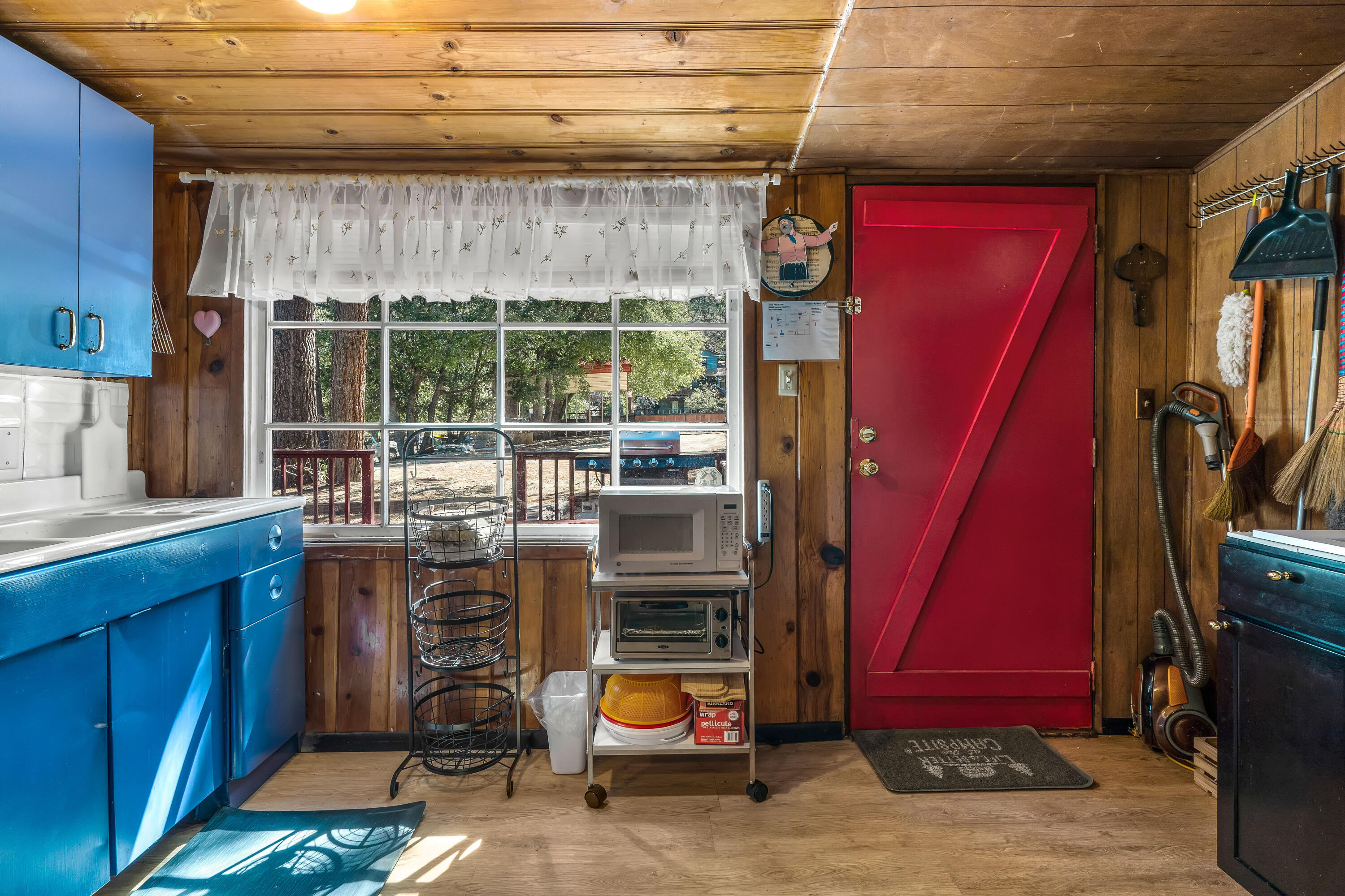 23061 Banning Idyllwild Road Idyllwild, CA 92549 - Photo 8 of 46 a kitchen with stainless steel appliances a stove a refrigerator and wooden cabinets