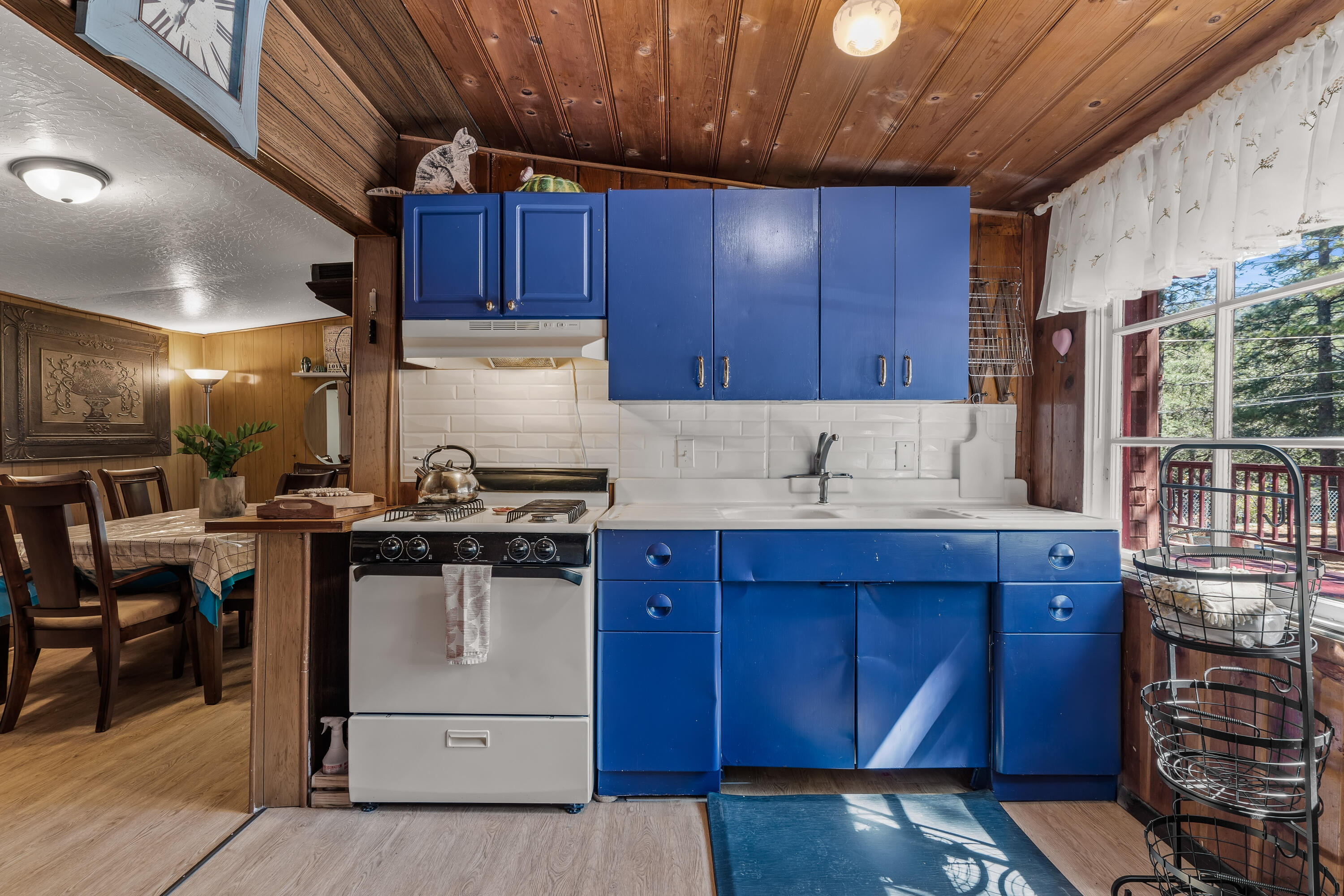 23061 Banning Idyllwild Road Idyllwild, CA 92549 - Photo 10 of 46 a kitchen with a sink a stove and cabinets