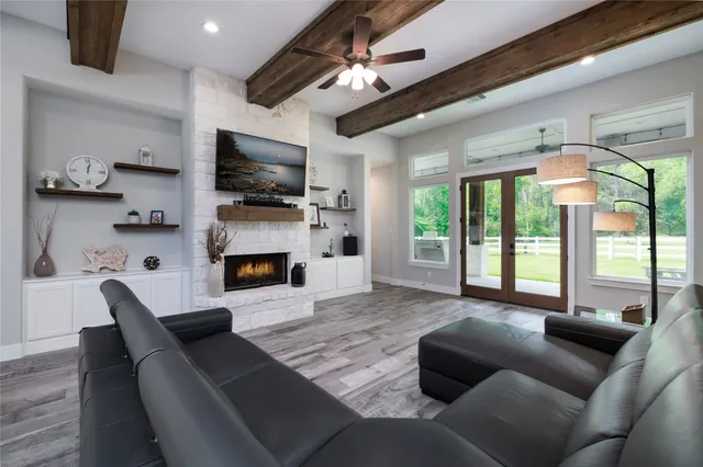a living room with furniture a flat screen tv and a fireplace