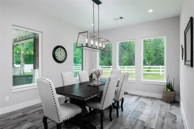 a large white kitchen with lots of counter space a sink and appliances