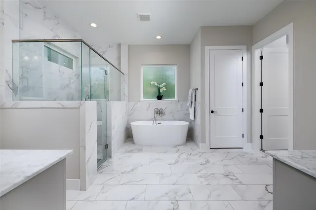 a bedroom with a bed and a flat tv screen on dresser