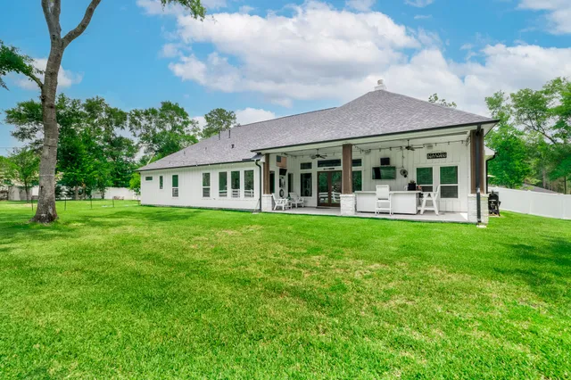 a view of a patio with table and chairs potted plants with the view of the house