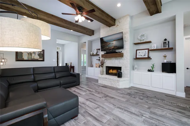 a living room with a couch kitchen view and a large window