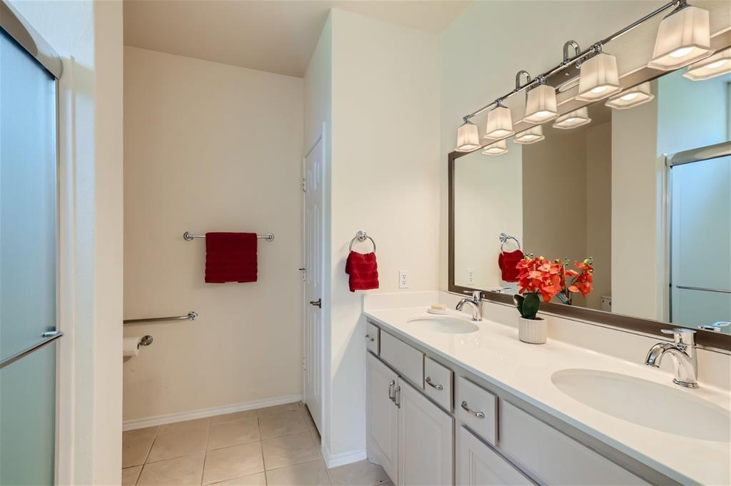 212 Summer Road Georgetown, TX 78633 - Photo 14 of 18 a bathroom with a double vanity sink mirror and shower