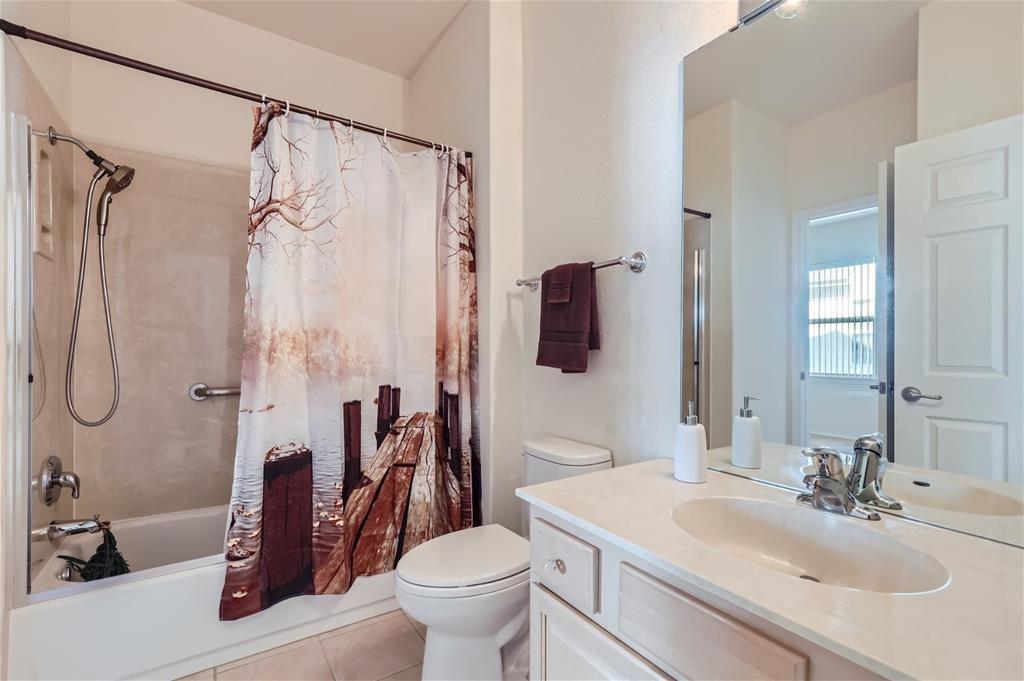 212 Summer Road Georgetown, TX 78633 - Photo 17 of 18 a bathroom with a sink toilet mirror and shower