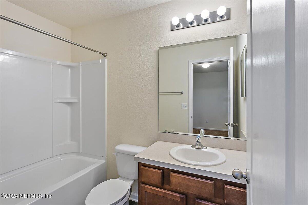 225 Whitland Way St. Augustine, FL 32086 - Photo 14 of 17 a bathroom with a sink toilet and shower