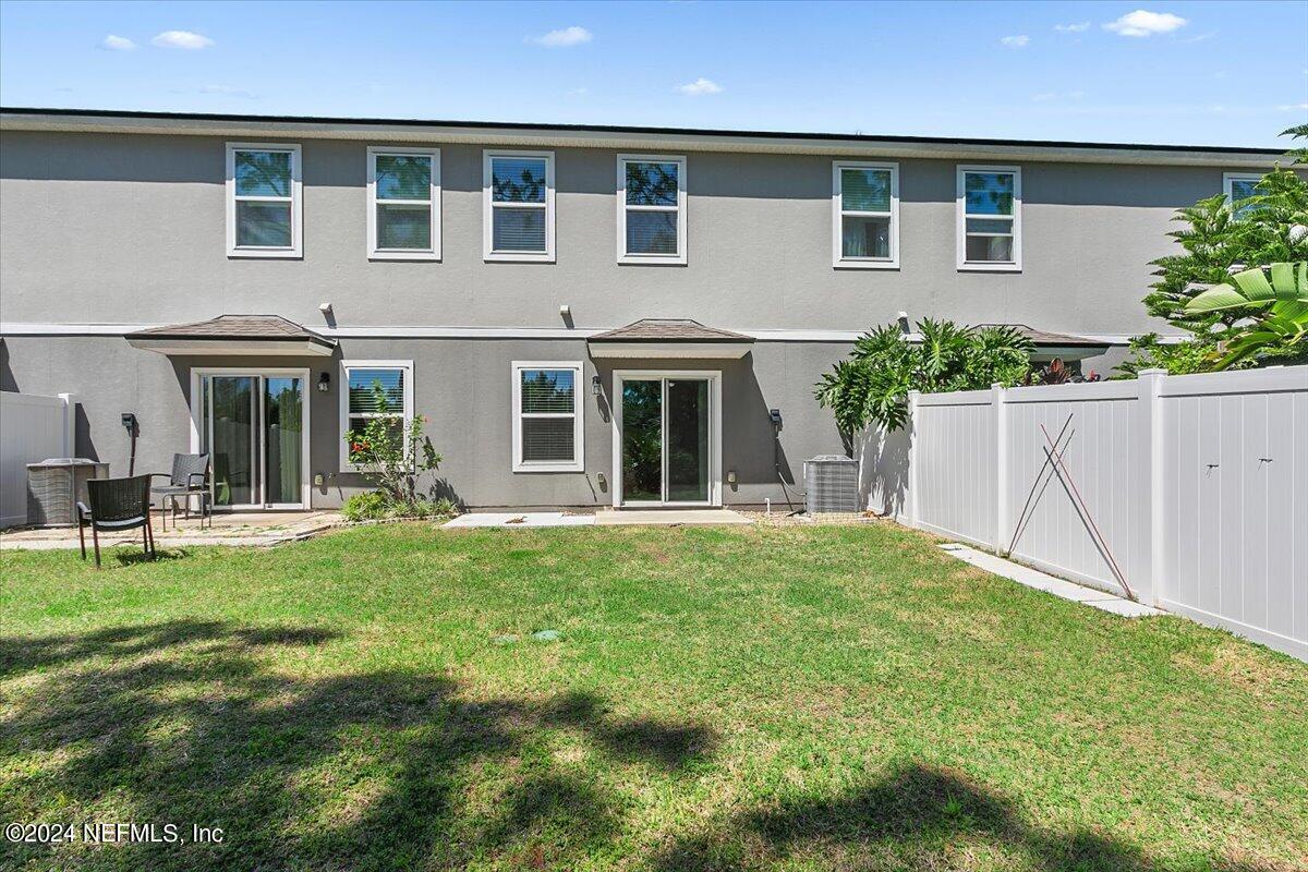 225 Whitland Way St. Augustine, FL 32086 - Photo 17 of 17 a backyard of a house with table and chairs