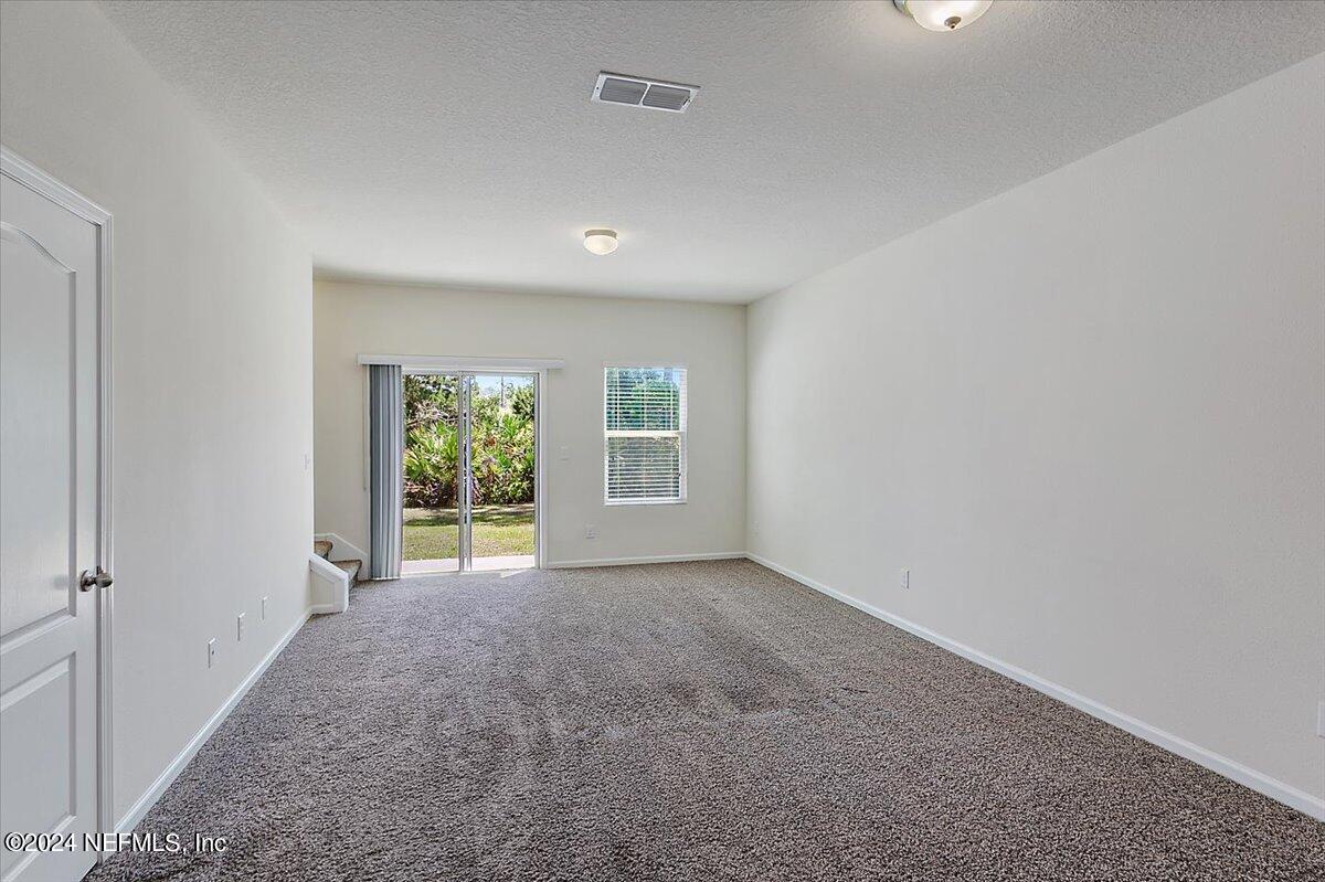 225 Whitland Way St. Augustine, FL 32086 - Photo 4 of 17 a view of an empty room with a window