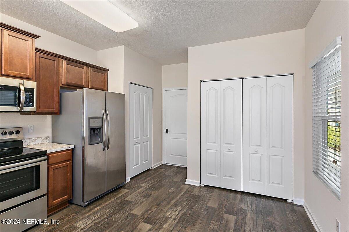 225 Whitland Way St. Augustine, FL 32086 - Photo 6 of 17 a kitchen with stainless steel appliances a refrigerator and microwave