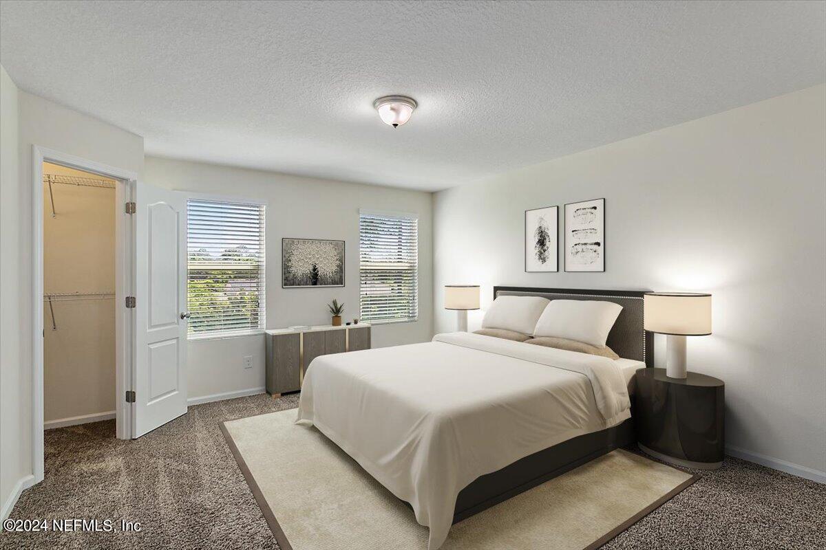 225 Whitland Way St. Augustine, FL 32086 - Photo 8 of 17 a bedroom with a large bed and a flat screen tv