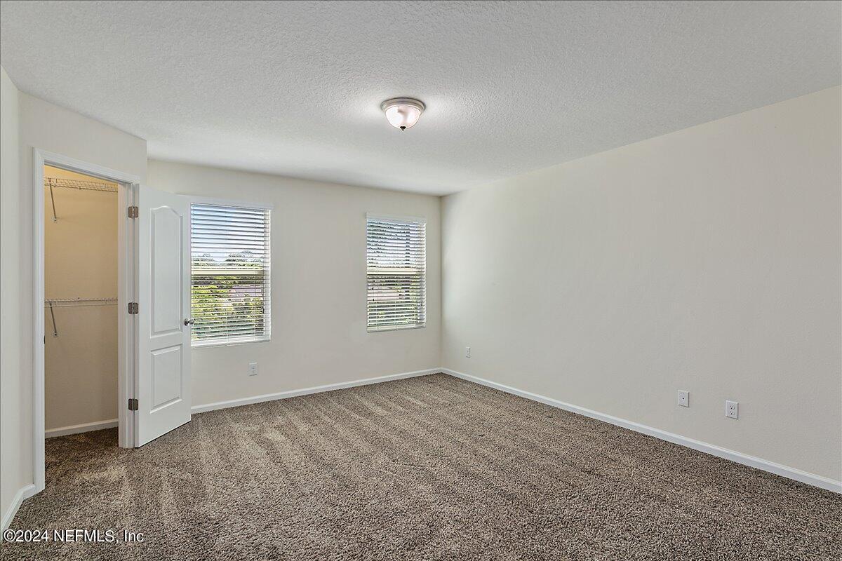 225 Whitland Way St. Augustine, FL 32086 - Photo 9 of 17 an empty room with windows