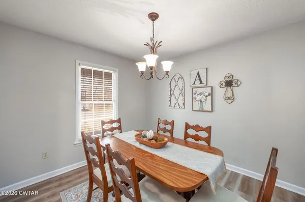 a view of a dining room with furniture and chandelier