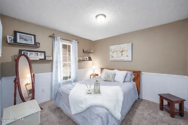 a bed room with a bed and a painting