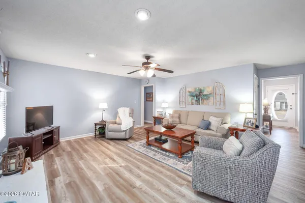 a bedroom with furniture and a flat screen tv