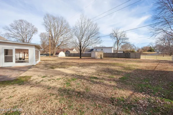 a view of a yard with a large tree