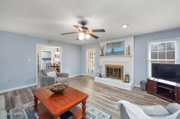 a living room with furniture a flat screen tv and a fireplace