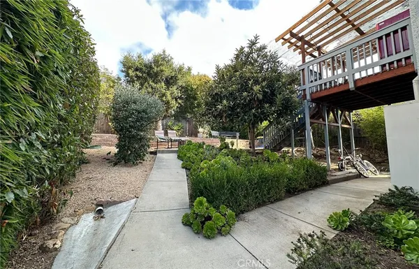 a view of a pathway with a garden