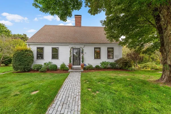 a front view of house with yard and green space